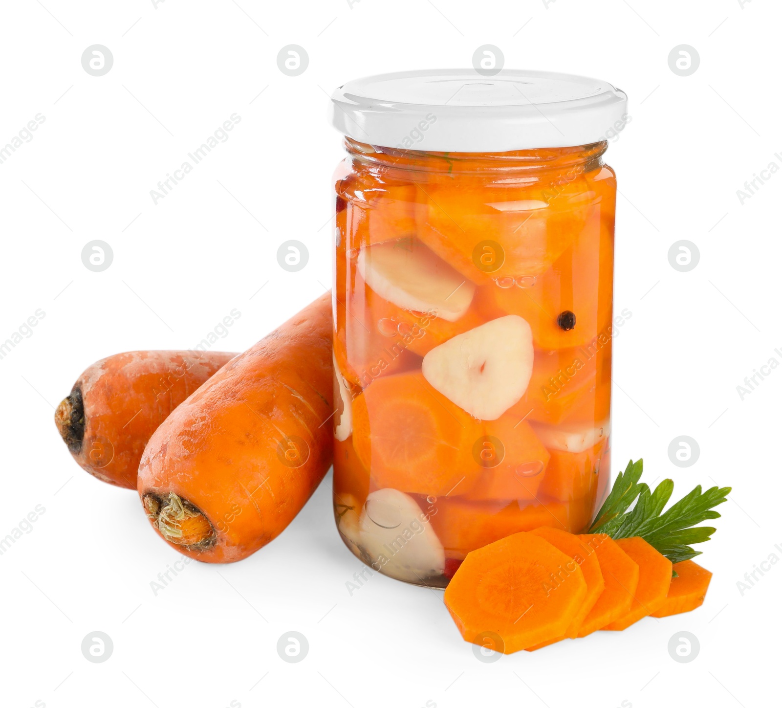 Photo of Tasty pickled carrots in jar and fresh ingredients isolated on white