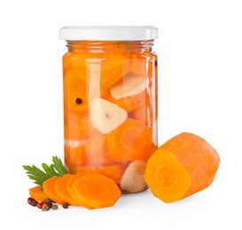 Photo of Tasty pickled carrots in jar and fresh ingredients isolated on white