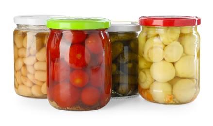 Photo of Different pickled products in jars isolated on white