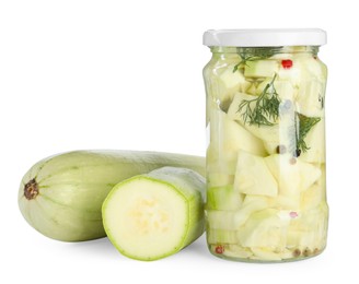 Photo of Tasty pickled zucchinis in jar and fresh vegetables isolated on white