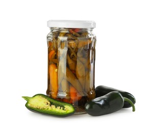 Photo of Tasty pickled jalapeno peppers in jar and fresh vegetables isolated on white