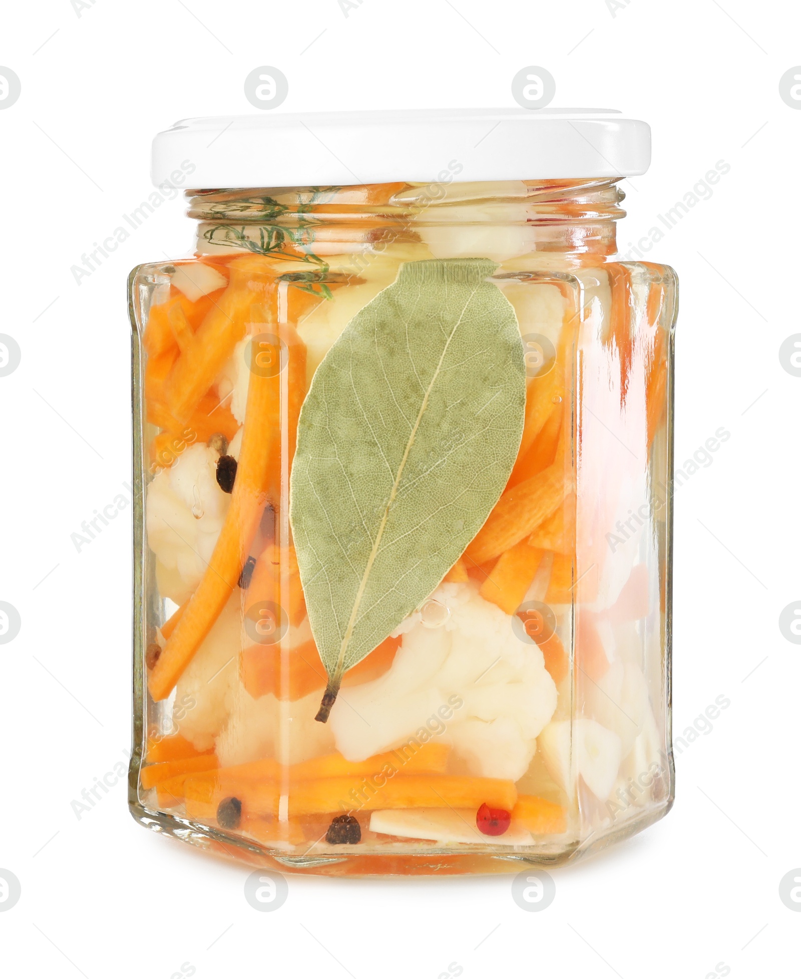 Photo of Tasty pickled carrots and cauliflower in jar isolated on white