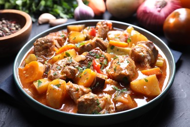 Photo of Delicious stew and different ingredients on table, closeup