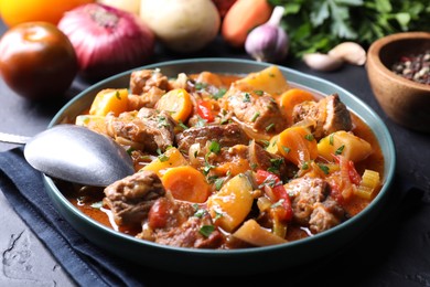 Photo of Delicious stew and different ingredients on table, closeup