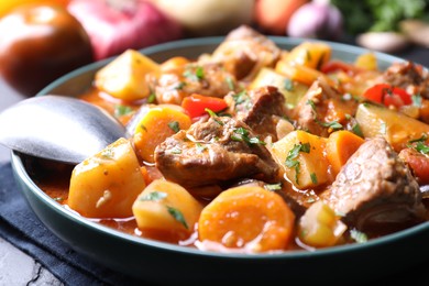 Photo of Delicious stew with vegetables on table, closeup