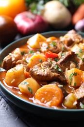 Photo of Delicious stew with vegetables on table, closeup