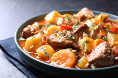 Photo of Delicious stew with vegetables on table, closeup