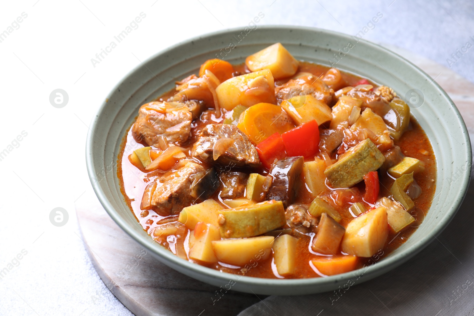 Photo of Delicious stew with vegetables in bowl on table, closeup