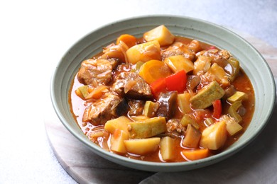 Photo of Delicious stew with vegetables in bowl on table, closeup