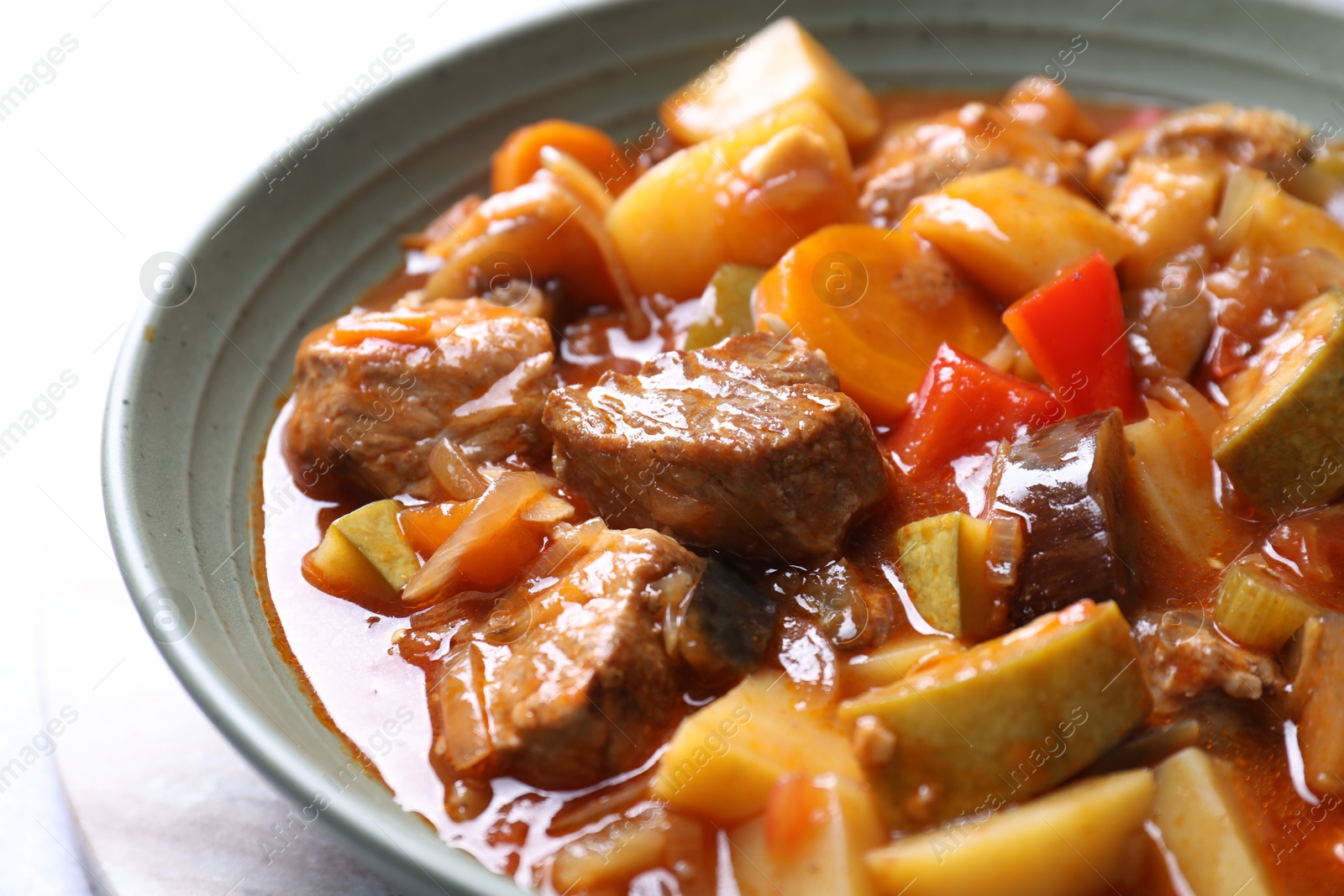 Photo of Delicious stew with vegetables in bowl on table, closeup