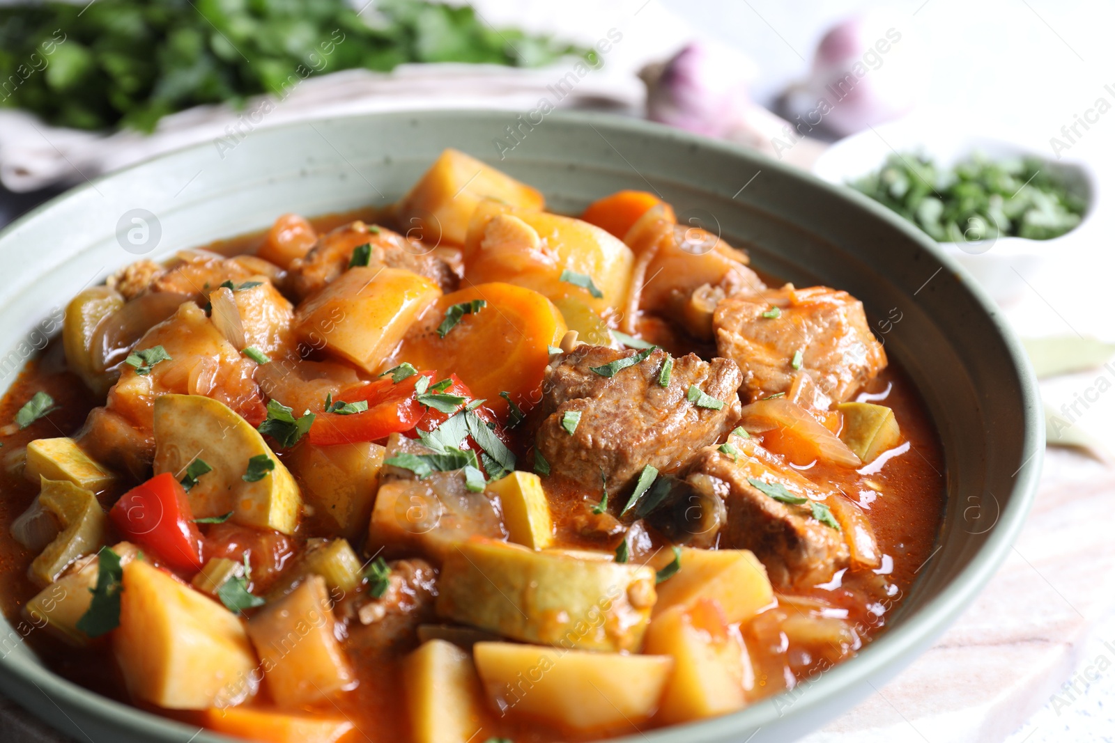 Photo of Delicious stew with vegetables in bowl on table, closeup