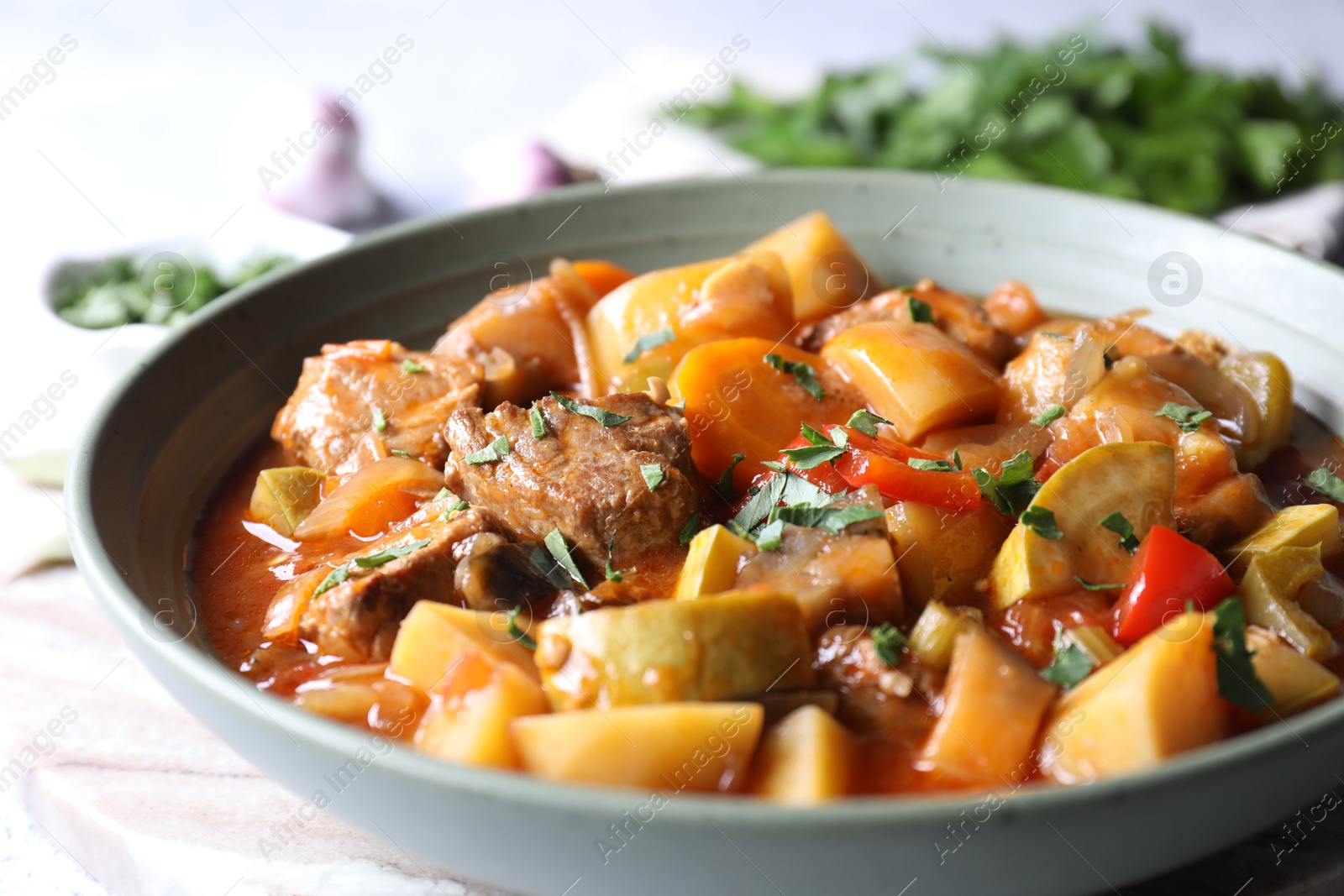 Photo of Delicious stew with vegetables in bowl on table, closeup