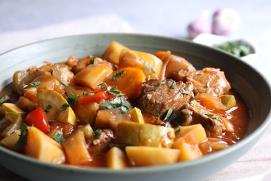 Photo of Delicious stew with vegetables in bowl on table, closeup