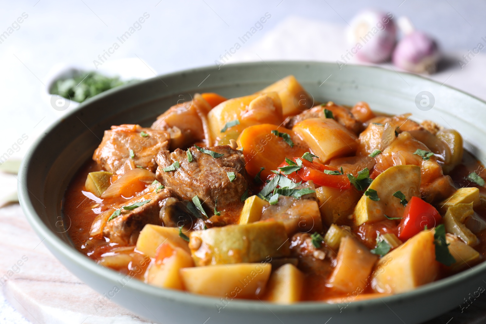 Photo of Delicious stew with vegetables in bowl on table, closeup