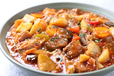 Photo of Delicious stew with vegetables in bowl on table, closeup