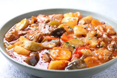 Photo of Delicious stew with vegetables in bowl on table, closeup