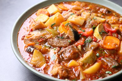 Photo of Delicious stew with vegetables in bowl on table, closeup