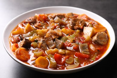 Photo of Delicious stew with vegetables in bowl on table, closeup