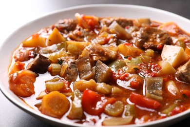 Delicious stew with vegetables in bowl on table, closeup