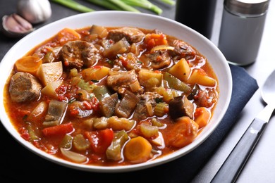 Photo of Delicious stew with vegetables in bowl on table, closeup