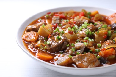 Delicious stew with vegetables in bowl on table, closeup