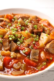 Photo of Delicious stew with vegetables in bowl on table, closeup