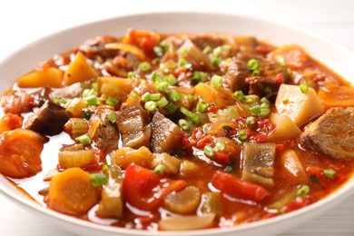 Delicious stew with vegetables in bowl on table, closeup