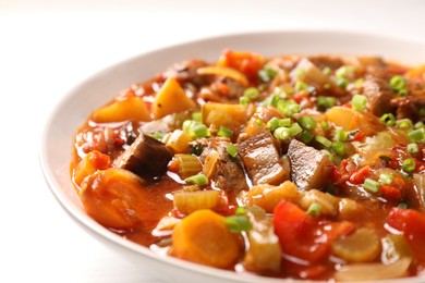 Delicious stew with vegetables in bowl on table, closeup