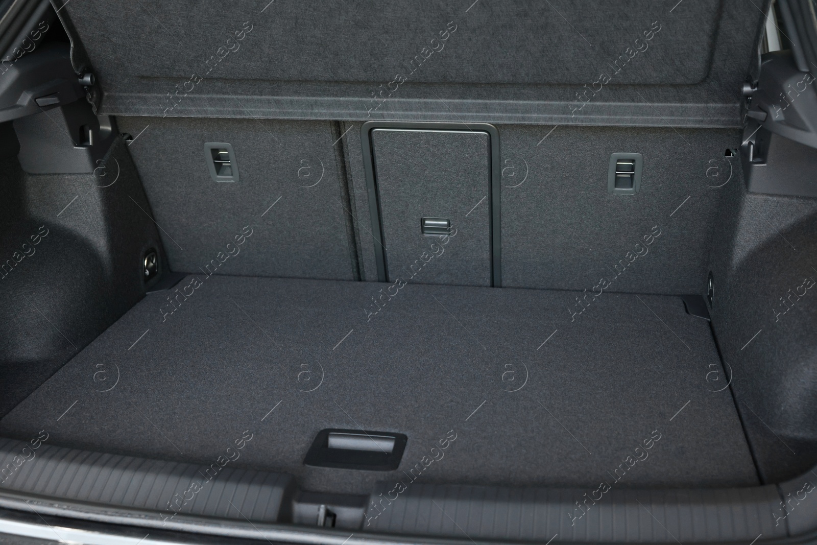 Photo of Grey soft car boot liner mat in trunk of auto