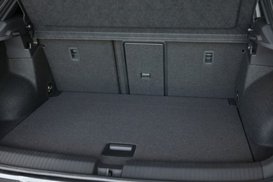 Photo of Grey soft car boot liner mat in trunk of auto