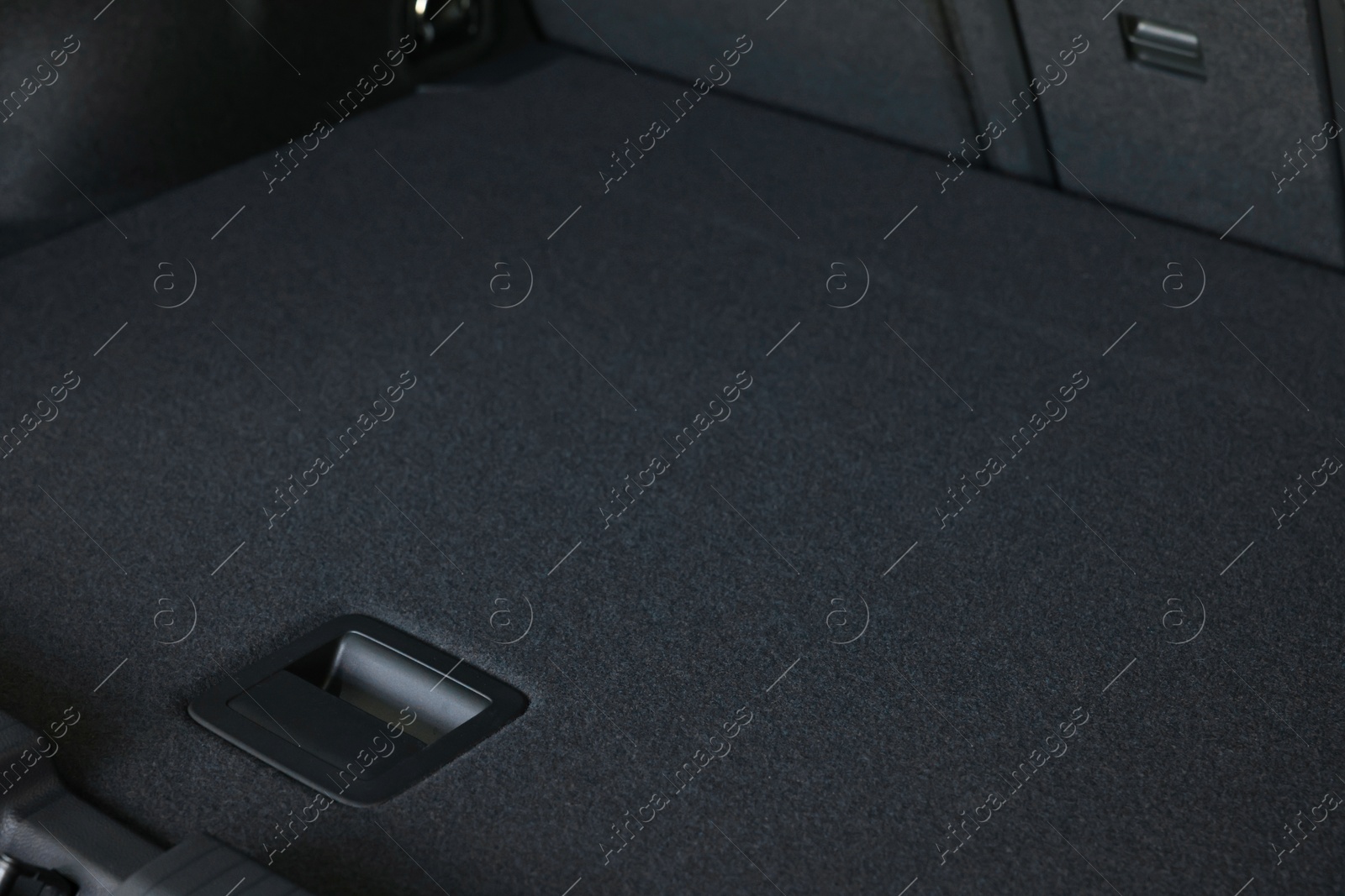 Photo of Grey soft car boot liner mat in trunk of auto