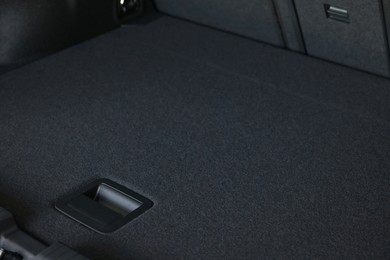 Photo of Grey soft car boot liner mat in trunk of auto