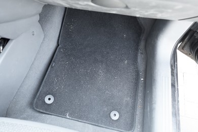 Photo of Black soft car floor mat in auto