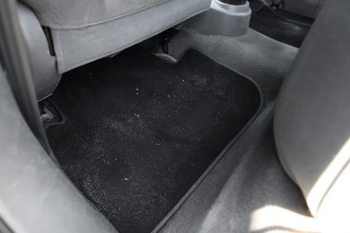 Photo of Black soft car floor mat in auto