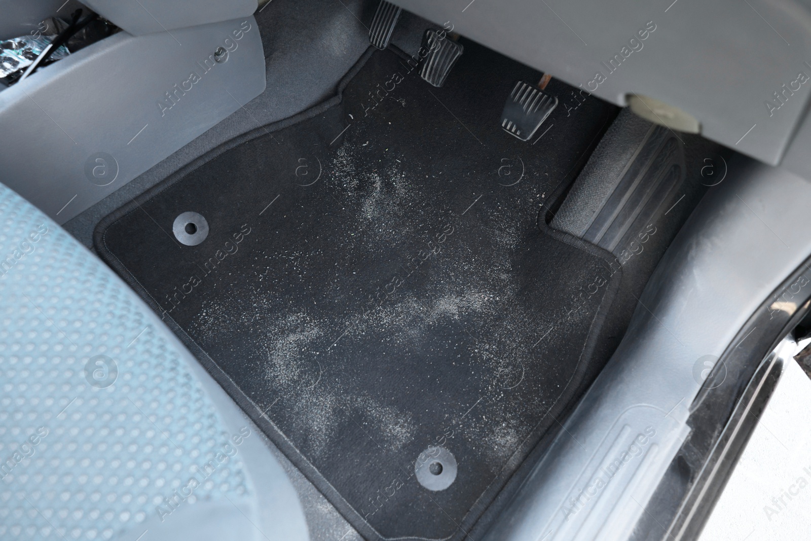 Photo of Black soft car floor mat in auto