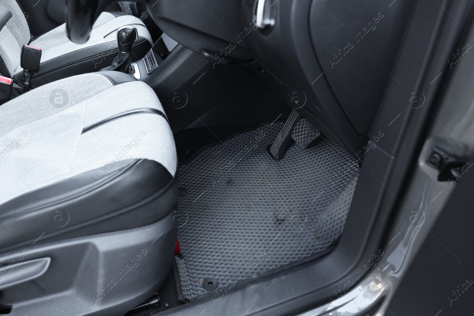 Photo of Grey rubber car floor mat in auto