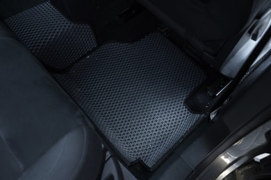 Photo of Grey rubber car floor mat in auto