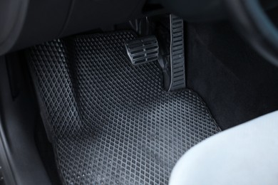 Photo of Dirty grey rubber car mat in auto