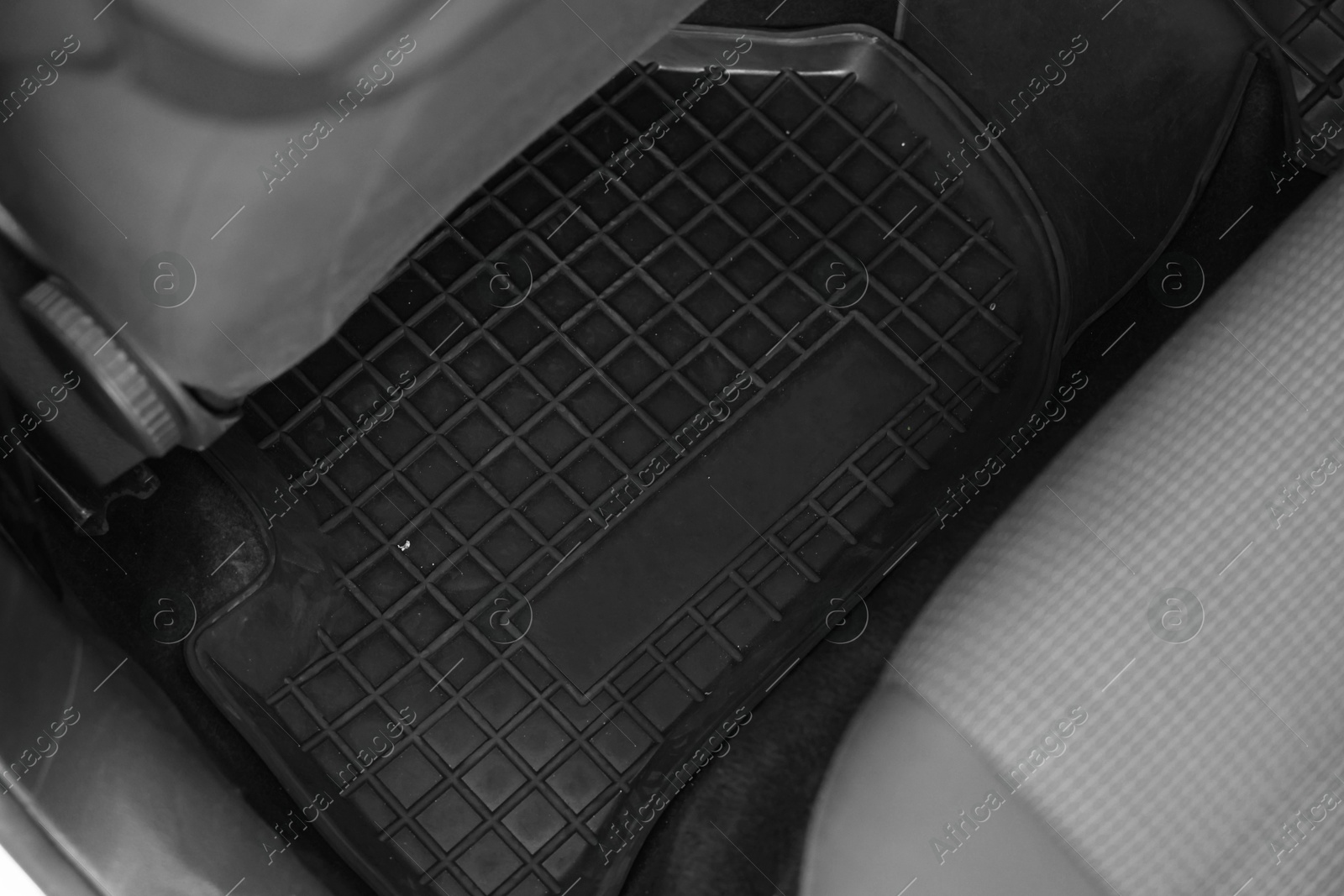 Photo of Black rubber car floor mat in auto