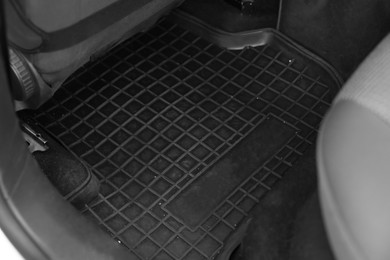 Photo of Black rubber car floor mat in auto