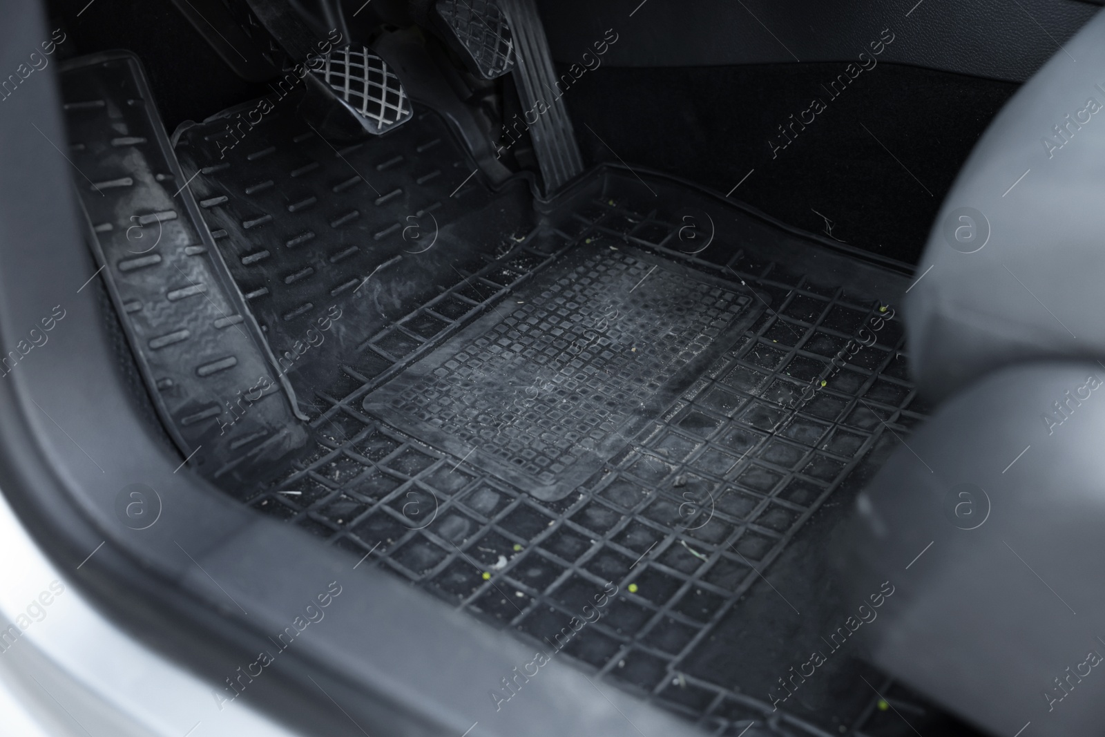 Photo of Black rubber car floor mat in auto