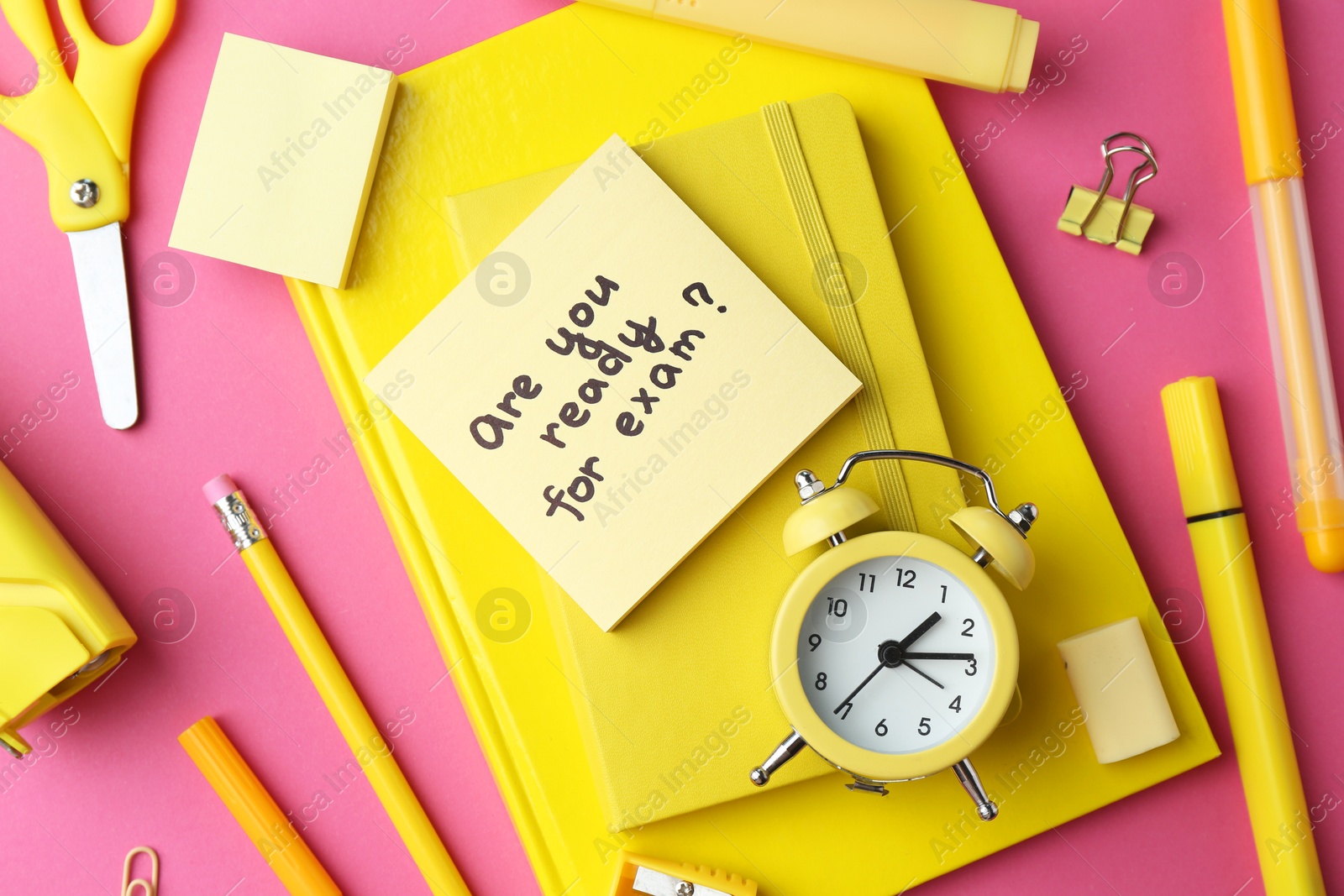 Photo of Paper note with question Are You Ready For Exam and stationery on pink background, flat lay