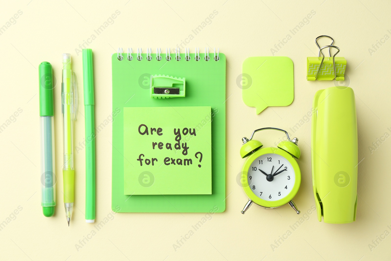 Photo of Paper note with question Are You Ready For Exam and stationery on pale yellow background, flat lay