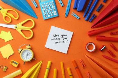 Photo of Paper note with question Are You Ready For Exam and stationery on orange background, flat lay