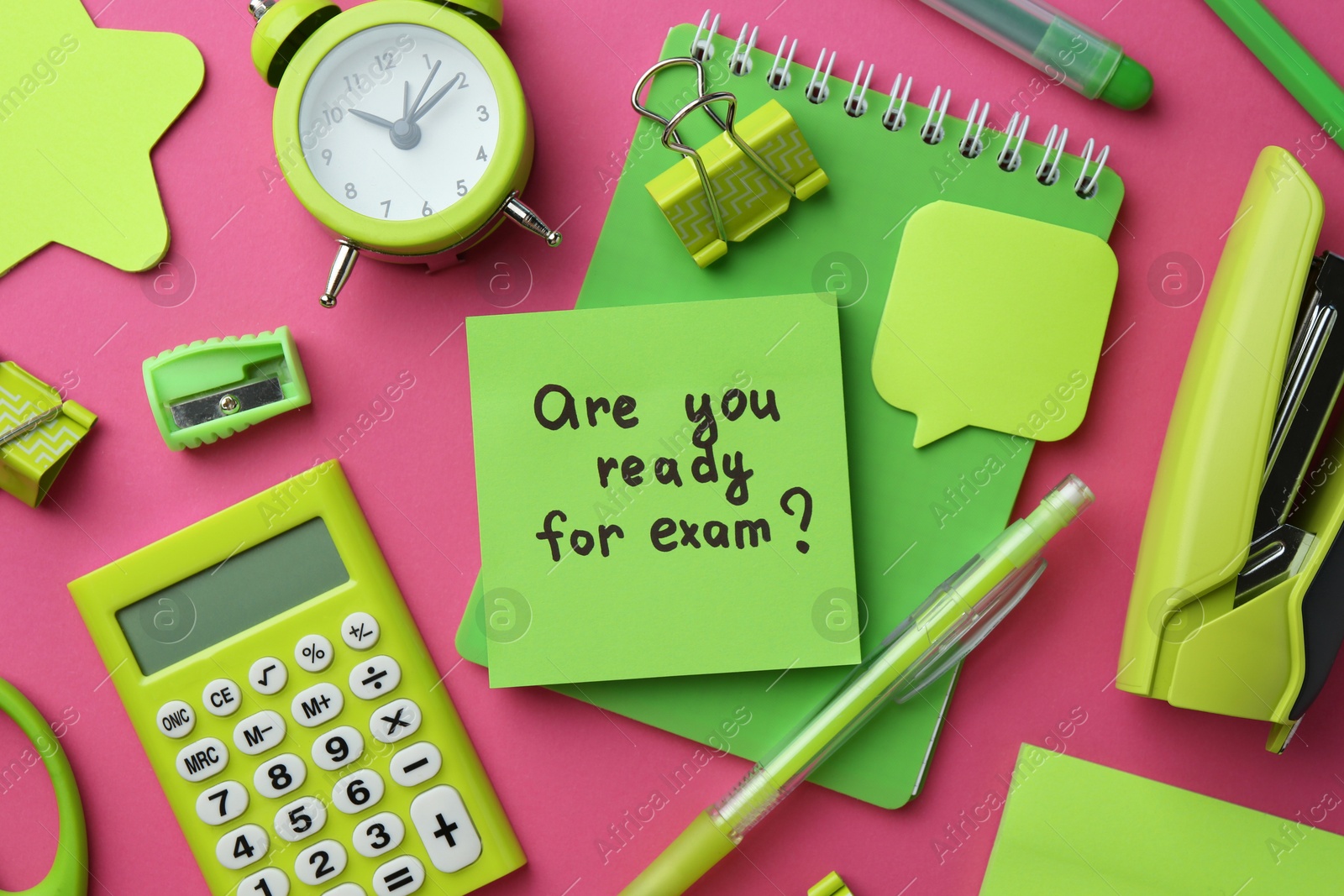 Photo of Paper note with question Are You Ready For Exam and stationery on green background, flat lay