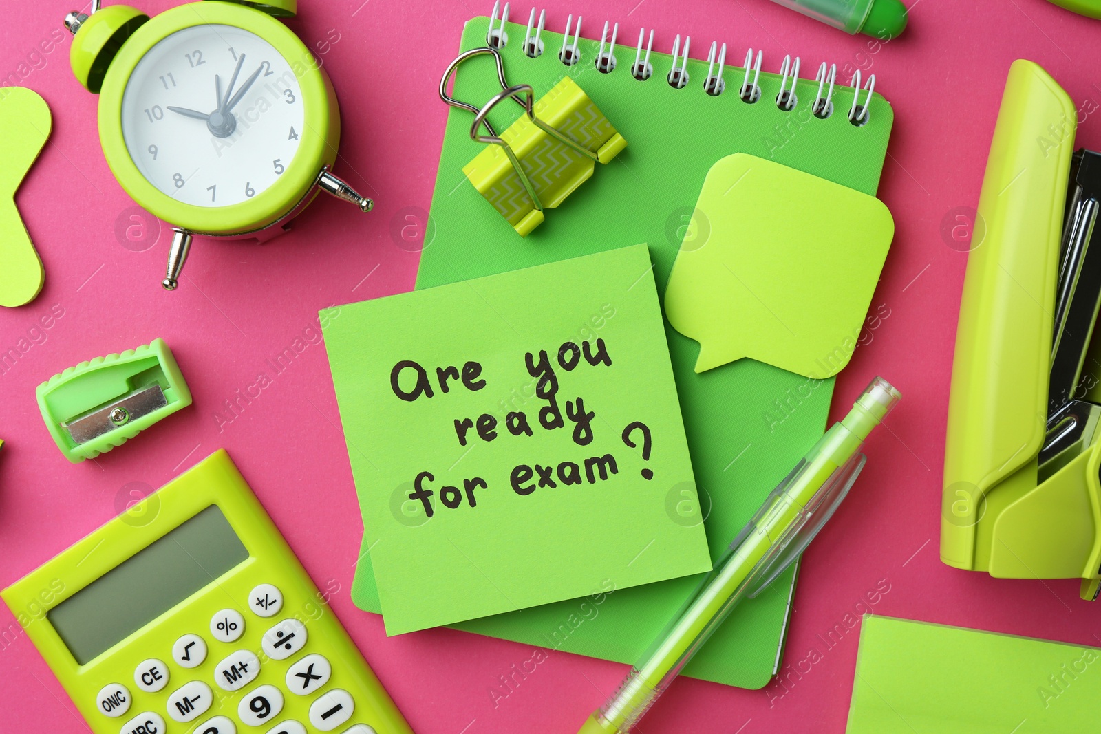 Photo of Paper note with question Are You Ready For Exam and stationery on green background, flat lay