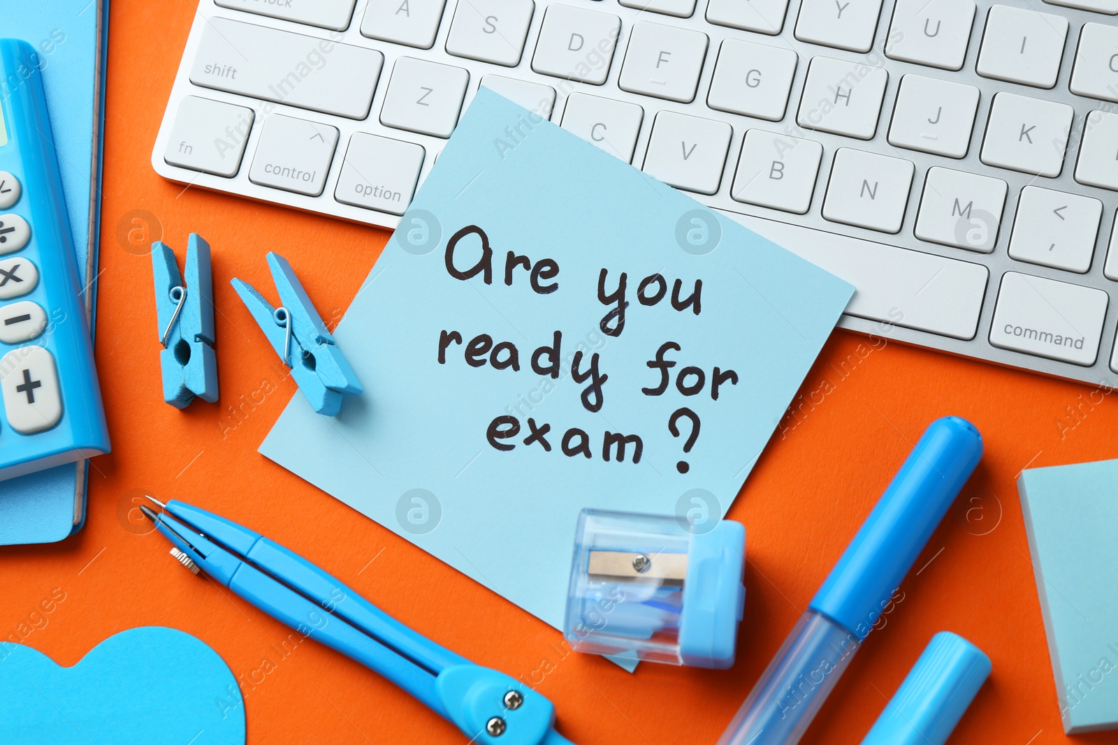 Photo of Paper note with question Are You Ready For Exam and stationery on orange background, flat lay