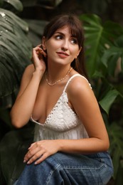 Photo of Portrait of beautiful woman in tropical forest