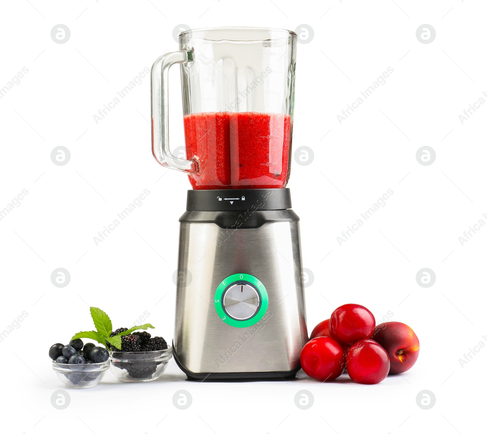 Photo of Blender with mixture of ingredients, fresh berries and fruits isolated on white