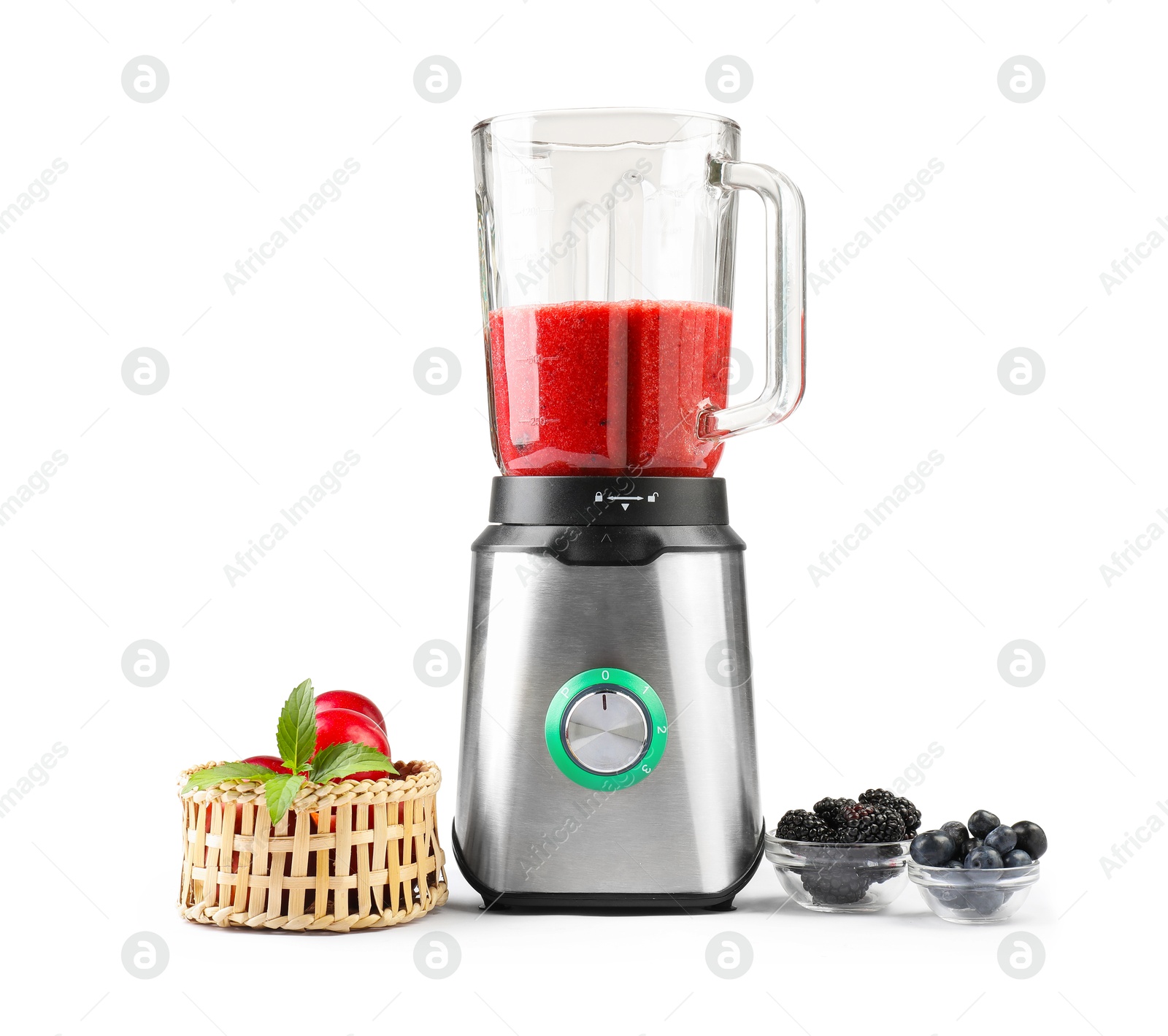 Photo of Blender with mixture of ingredients, fresh berries and fruits isolated on white